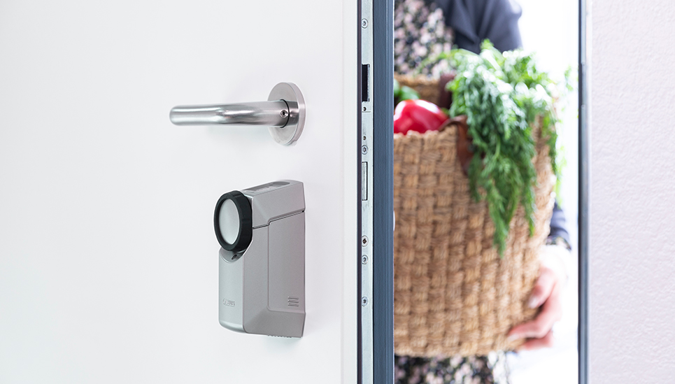 Swipe on "Unlock" in the app and your front door unlocks and also pops open a crack. © ABUS